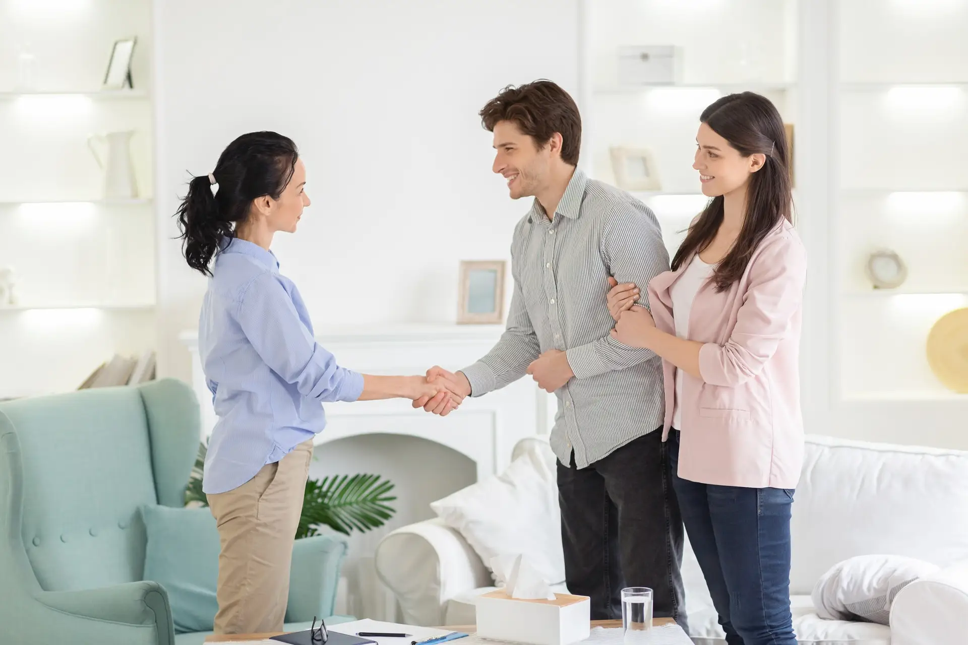 Psychologist And Thankful Couple Handshaking In Office